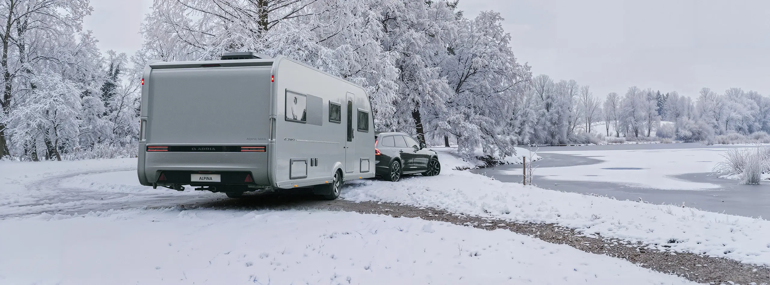 Silver ADRIA ALPINA 2027 in a winter landscape
